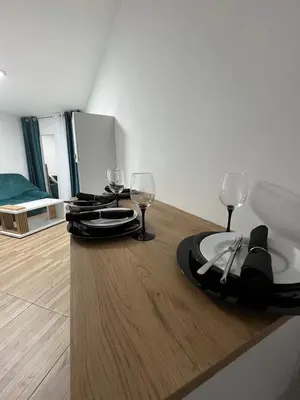 a dining table with wine glasses on top of it at Budva apartman Vasić in Budva