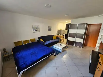 a living room with a blue bed and a couch at Studio Apartment Blue Dream in Kotor