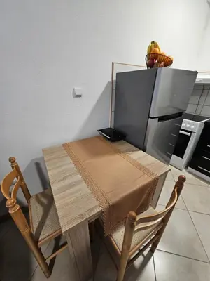 a kitchen with a table and a refrigerator at Studio Apartment Blue Dream in Kotor