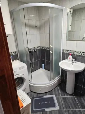 a bathroom with a washing machine and a sink at Studio Apartment Blue Dream in Kotor