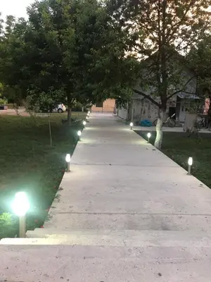 a long pathway with lights on the grass at Casa Calda Apartments in Cetinje