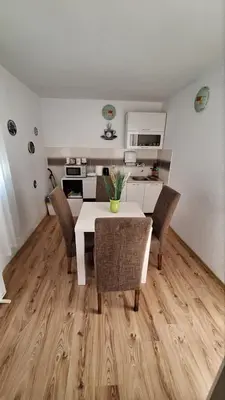 a kitchen and dining room with a table and chairs at Casa Calda Apartments in Cetinje