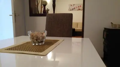 a glass vase with rocks in it sitting on a table at Casa Calda Apartments in Cetinje