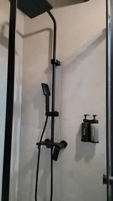 a shower in a bathroom with a blow dryer at Cottage MATEJ in Podgorica