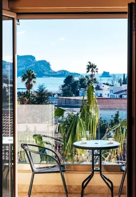 a table and a chair in front of a window at Sea-view PD38 by In Property in Budva