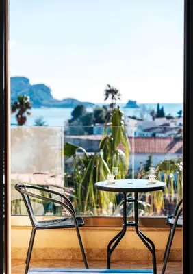 a table and two chairs in front of a window at Sea-view PD38 by In Property in Budva