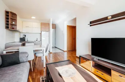 a living room with a couch and a tv at Sea-view PD38 by In Property in Budva