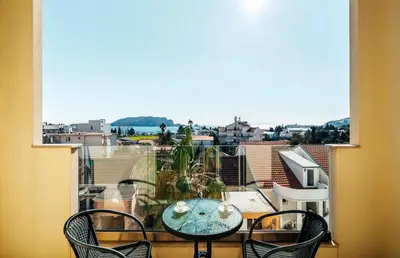 a view of a balcony with a table and chairs at Sea-view PD38 by In Property in Budva