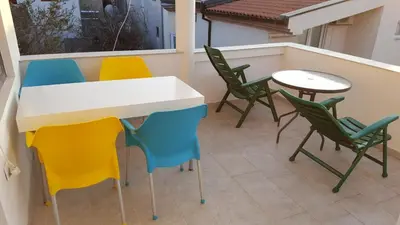 a patio with chairs and a table on a balcony at Dzenan apartmani in Dobra Voda