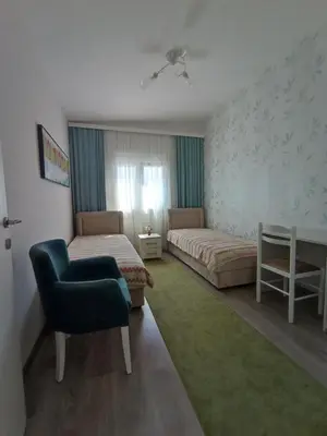 a hotel room with two beds and a chair at Dubrava 112 in Dobra Voda