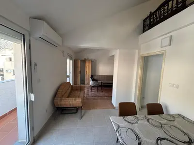 a room with a bed and a couch and a table at Apartman Horizont in Petrovac na Moru