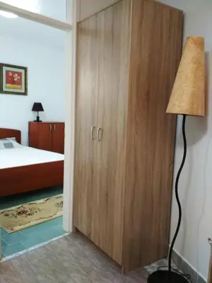 a bedroom with a closet and a floor lamp at Comfort Apartments in Bar
