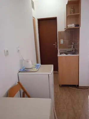 a small kitchen with a sink and a counter top at Comfort Apartments in Bar