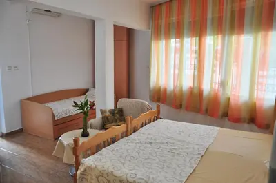 a bedroom with two beds and a window at Comfort Apartments in Bar