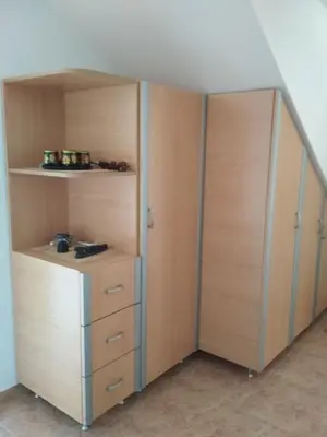 a closet with wooden shelves and a closet door at Comfort Apartments in Bar