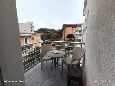 a balcony with a table and chairs on a building at Villa Sun Budva in Budva