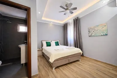 a bedroom with a bed and a bathroom at Villa Sun Budva in Budva