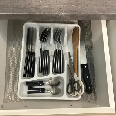 a plastic container filled with utensils in a drawer at Villa Sun Budva in Budva