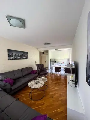 a living room with a couch and a table at Sky apartment - Becici in Becici