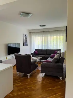 a living room with a couch and two chairs at Sky apartment - Becici in Becici