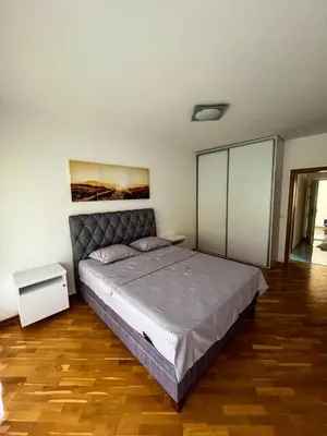 a bedroom with a large bed in a room at Sky apartment - Becici in Becici
