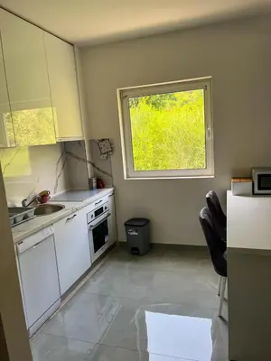 a kitchen with a sink and a window at Sky apartment - Becici in Becici