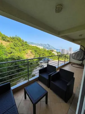a balcony with chairs and tables and a view at Sky apartment - Becici in Becici