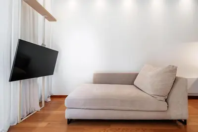 a living room with a couch and a flat screen tv at Central APT 11 by In Property in Budva