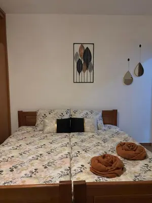 a bed with two brown pillows on top of it at Nikolaj in Podgorica
