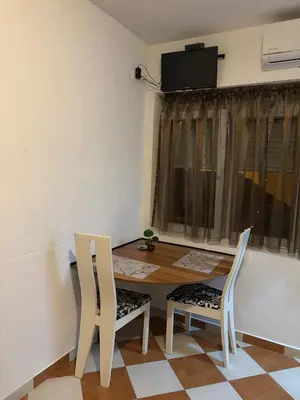 a dining room with a table and two chairs at Nikolaj in Podgorica