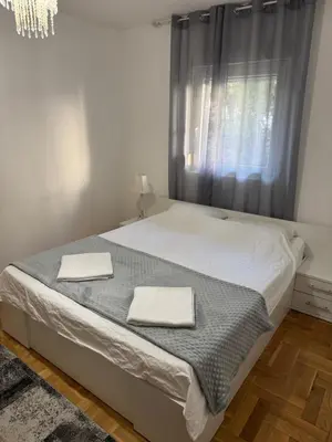 a bedroom with a bed with two towels on it at Villa Bait in Bar