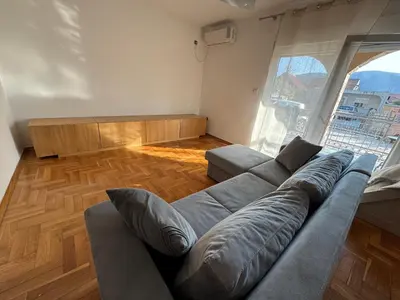 a living room with a couch and a large window at Villa Bait in Bar
