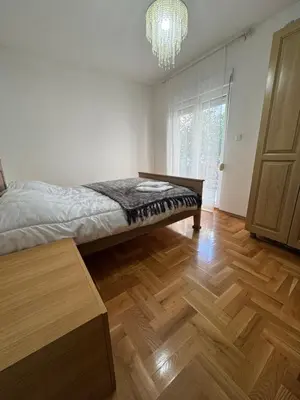 a bedroom with a bed and a wooden floor at Villa Bait in Bar