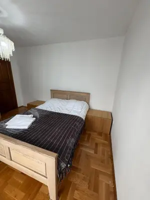 a bed in a room with a wooden floor at Villa Bait in Bar