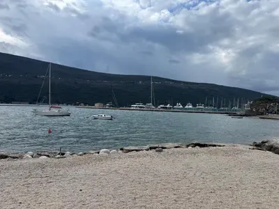 two boats sitting in the water near a beach at Villa Bait in Bar