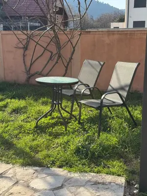 two chairs and a table in the grass at Villa Bait in Bar