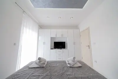 a white room with two pillows on a bed at Villa Bojana in Neodi