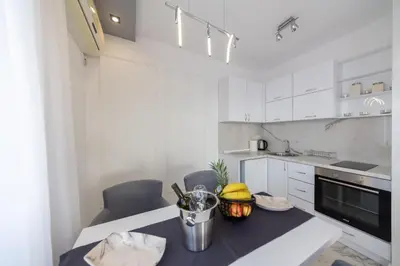 a kitchen with a table with a bowl of fruit on it at Villa Bojana in Neodi