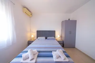 a bedroom with a bed with towels on it at Villa Bojana in Neodi