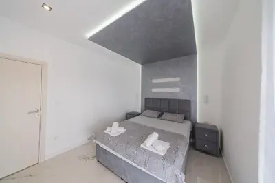a bedroom with a bed with two towels on it at Villa Bojana in Neodi