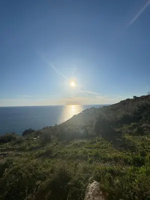 a view of the sun rising over the ocean at Apartments Azimut Rezevici in Budva