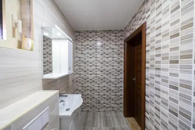 a bathroom with a sink and a toilet and a mirror at Luča Apartments in Budva