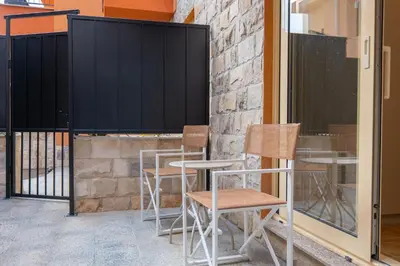 a group of chairs and tables on a patio at Luča Apartments in Budva