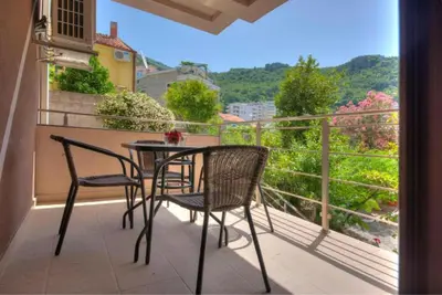 a table and chairs on a balcony with a view at Sea Point apartment Korda in Budva
