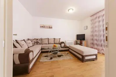 a living room with a couch and a table at Sea Point apartment Korda in Budva