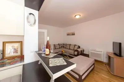 a living room with a couch and a table at Sea Point apartment Korda in Budva