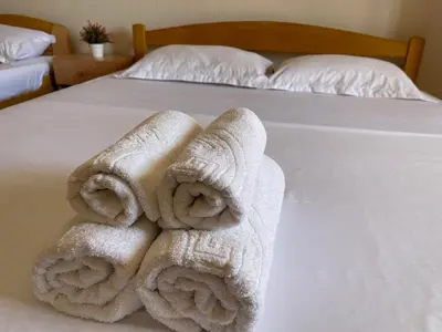 a bed with two rolled towels on it at SOHO Apartments in Ulcinj