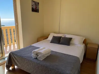 a bedroom with a bed with towels on it at SOHO Apartments in Ulcinj