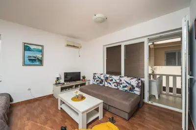 a living room with a couch and a table at Apartments Franićević in Petrovac na Moru
