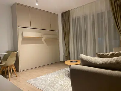a living room with a couch and a table at Golden Nook in Podgorica